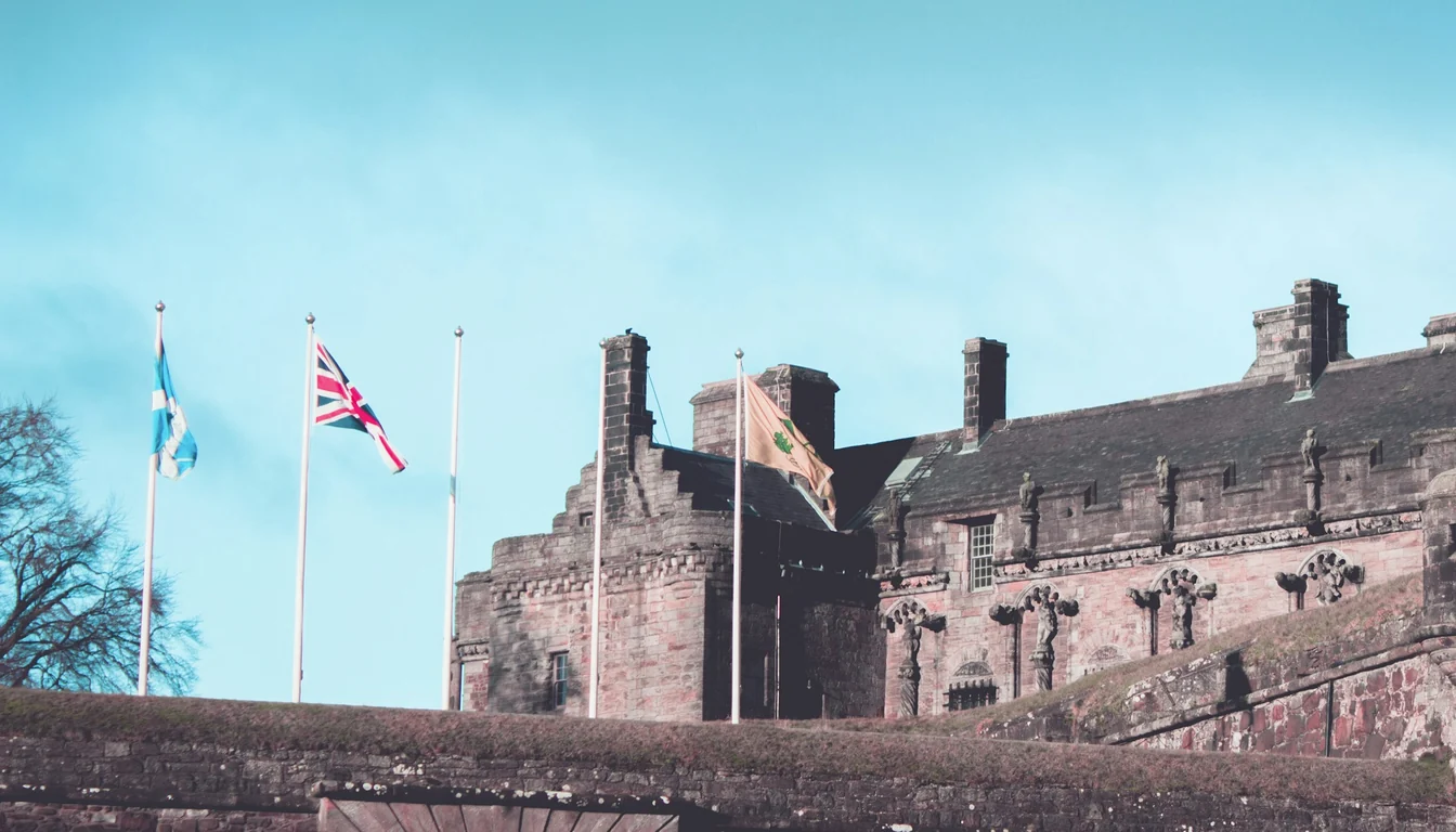 Stirling Castle stone buildings with flags above the entrance